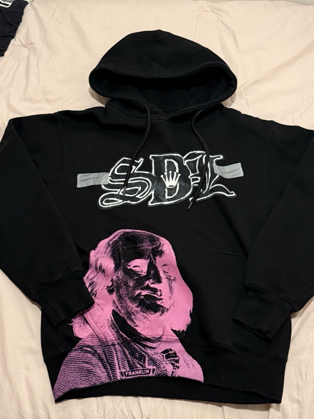SDL black pullover hoodie featuring a striking hot pink Benjamin Franklin Small